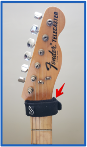 guitar string dampener-Image of a Fretwrap on a guitar headstock