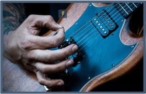 Improve Guitar Playing-Image of a right hand of a guitarist