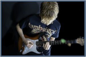 Improve Guitar Playing-Image of young guitarist playing a guitar