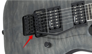 Super Strat guitars-Image of a Floyd Rose Bridge and Nut locking system on Jackson JS Dinky