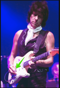 jeff beck's guitar style-Image of Beck playing without a pick in his right hand.