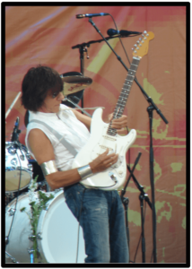 jeff beck's guitar style-Image of Artist playing live with his white signature strat
