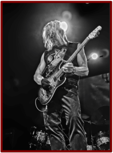 Active vs Passive Guitar Pickups -Image of a Steve Morse on stage playing his Music man guitar 
