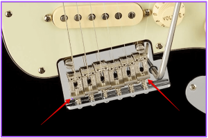 guitar scale length explained- Image of a Fender Strat Bridge and the different starting points on the saddles
