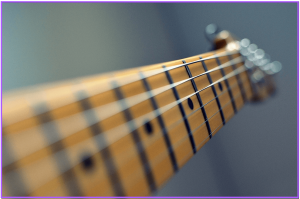 guitar scale length explained- Image of maple guitar neck with Strings 