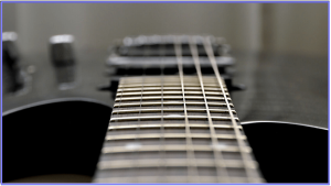 multi scale guitar- Image of a 6 string guitar looking down from the neck 