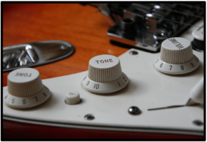 7 Ways To- Upgrade An Electric Guitar-Image of a control knobs on a Fender Strat 