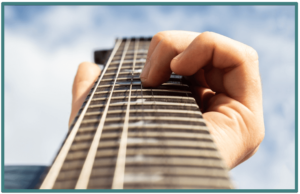 Scalloped Guitar Fretboard -Image of a guitar player bending notes on a fingerboard