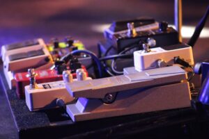 How To Get Back Onstage- An image of a guitar peddle board with various peddles 