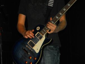 How To Get Back Onstage- An image of a guitarist warming up on his guitar 