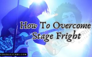 how to overcome stage fright with- and image of a guitarist onstage playing live