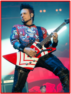 Jason hook signature guitar-Image of Jason Hook playing his red and white Gibson Explorer live on stage