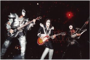 Remembering Ace Frehley - image of Ace Frehley on stage with the original band members for 1999 reunion tour